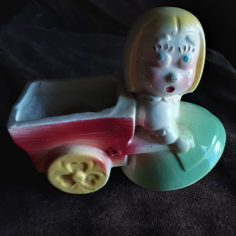 Surprised girl pulling a wagon ceramic flower pot/vase